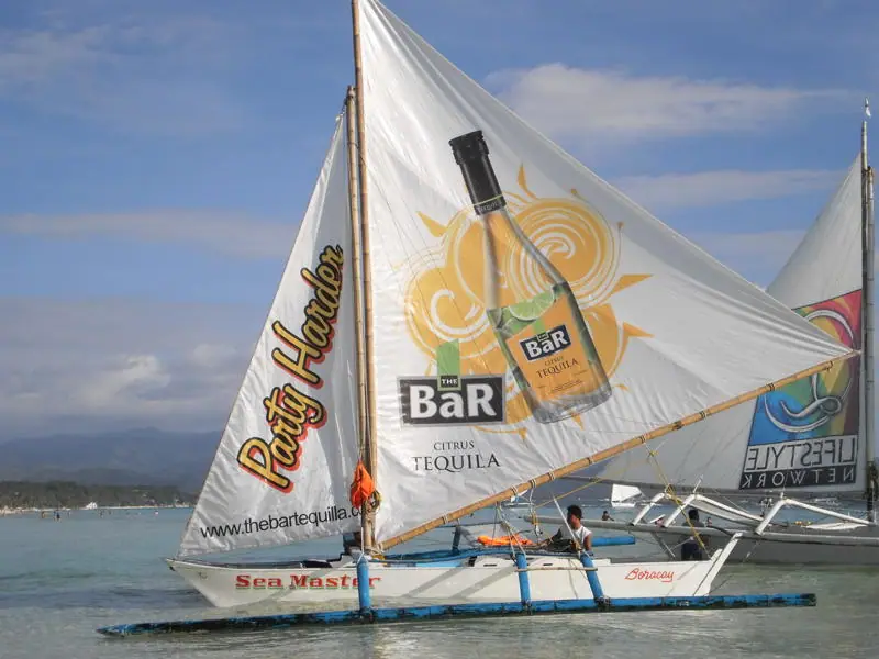 Printed advertising sail on a paraw sailboat