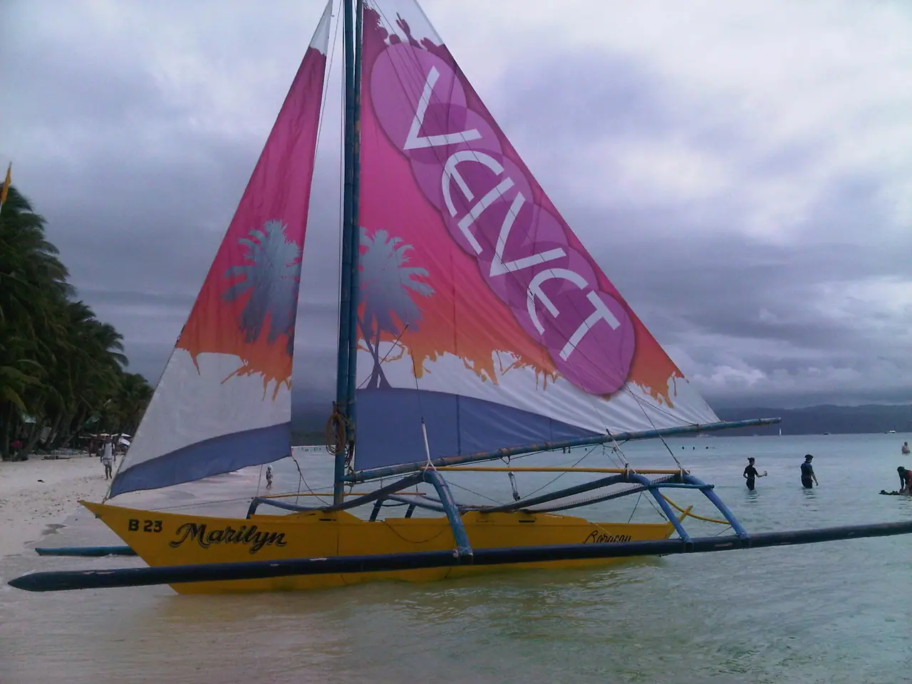 Printed sail on a paraw sailboat on the beach