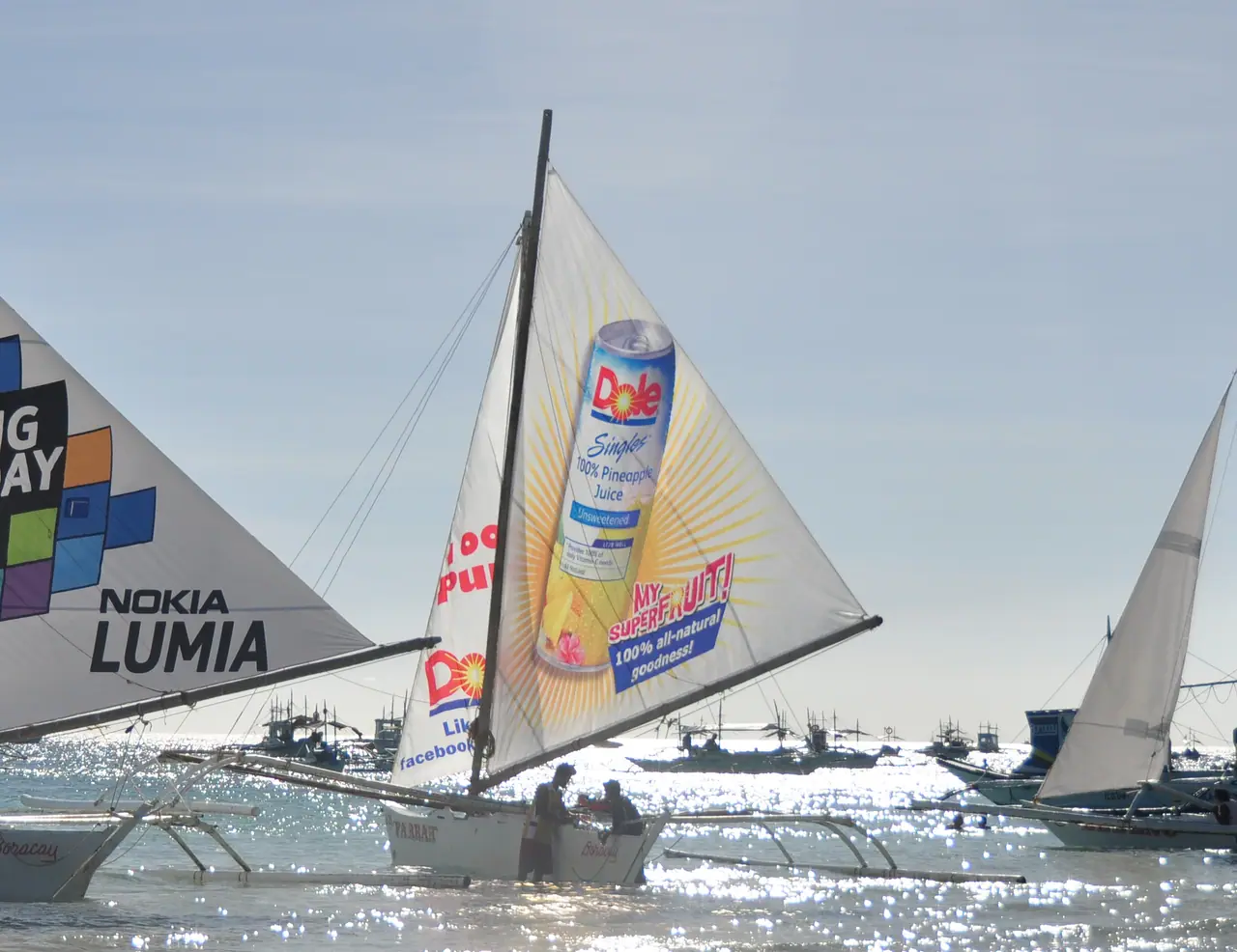 Beverage advertising sail on a paraw sailboat
