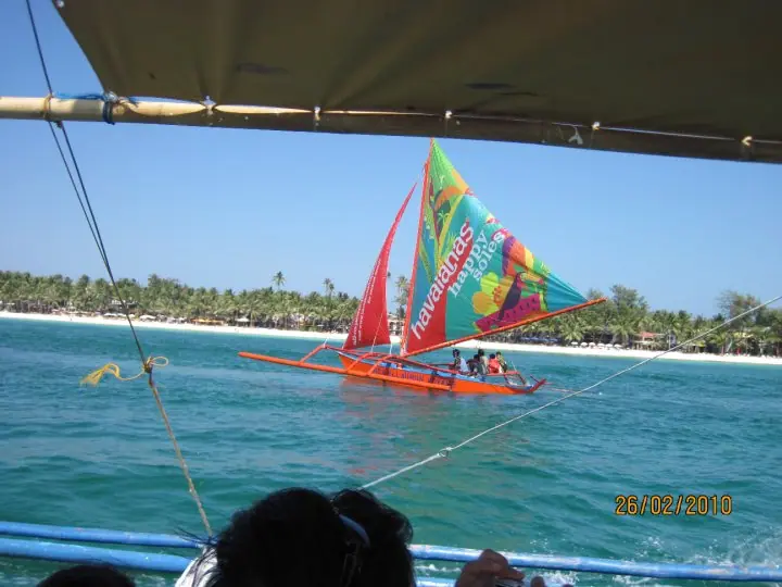 Multicolored printed sail out on the water