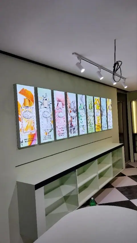 Row of framed fabric lightboxes along a corridor