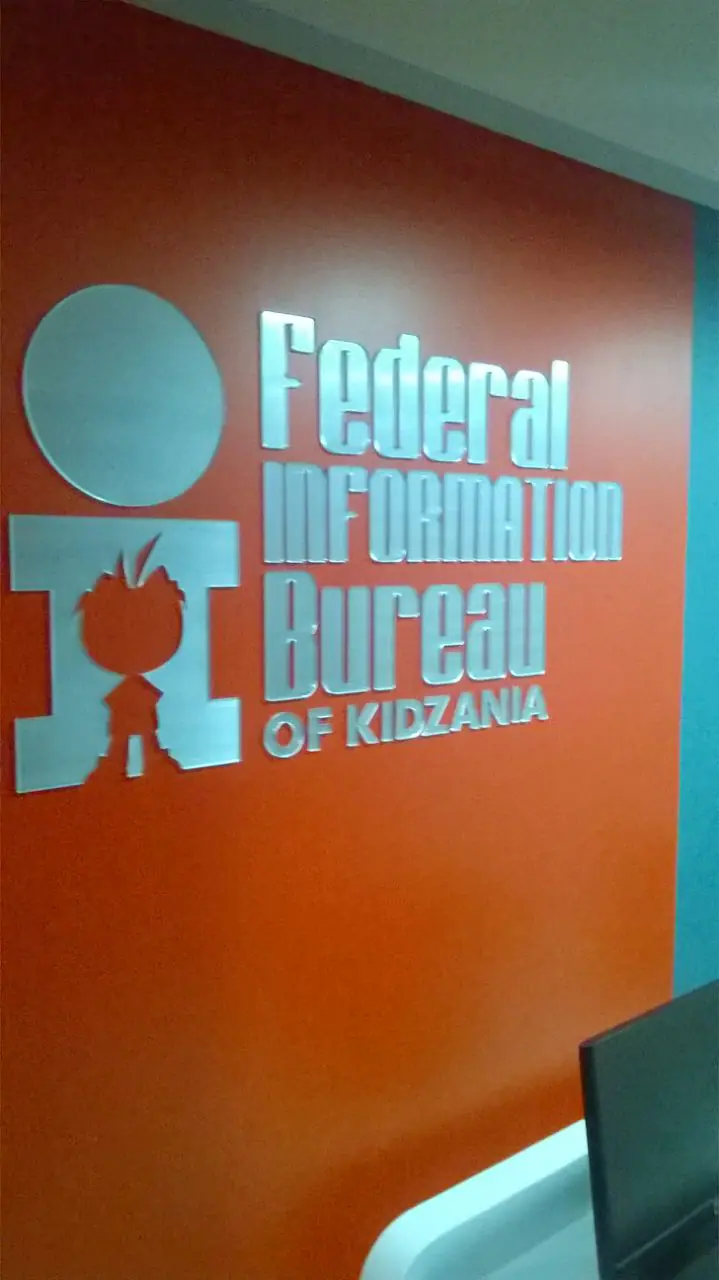 Dimensional lettering on an orange feature wall
