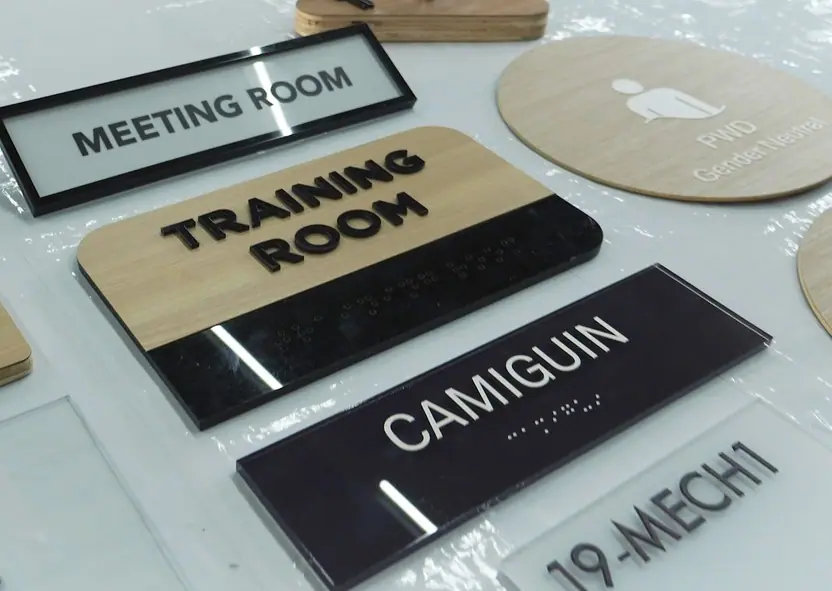 Room identification signs in wood and black acrylic
