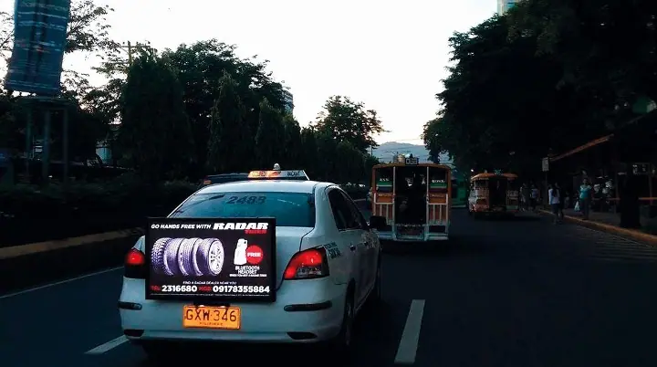 Lighted rear-window advertisement on a taxi