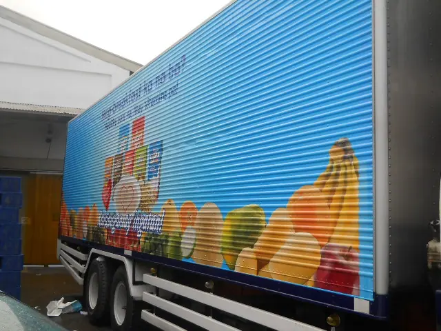 Fruit-themed graphics on a trailer truck