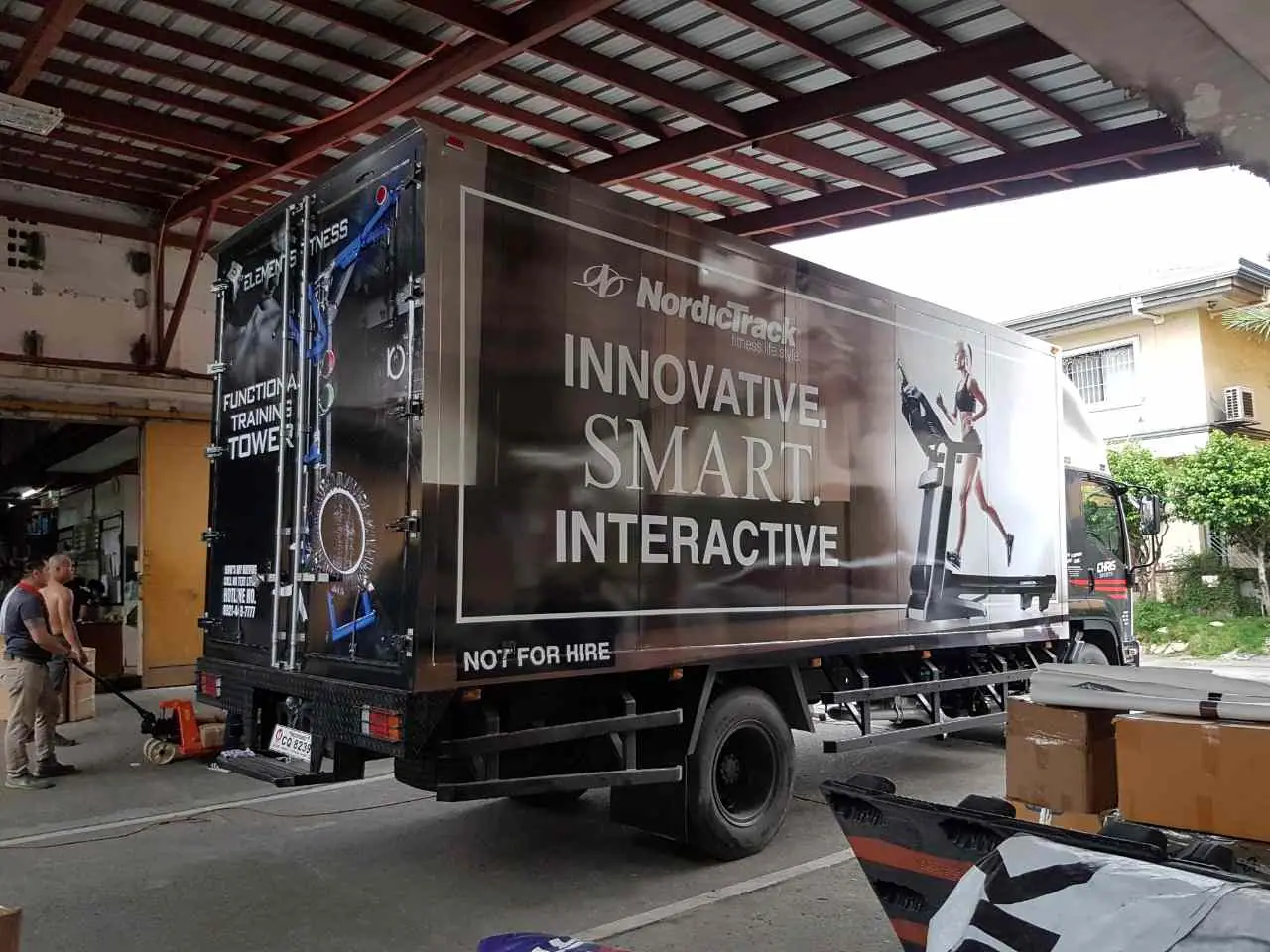 Dark fitness brand graphics on a box truck