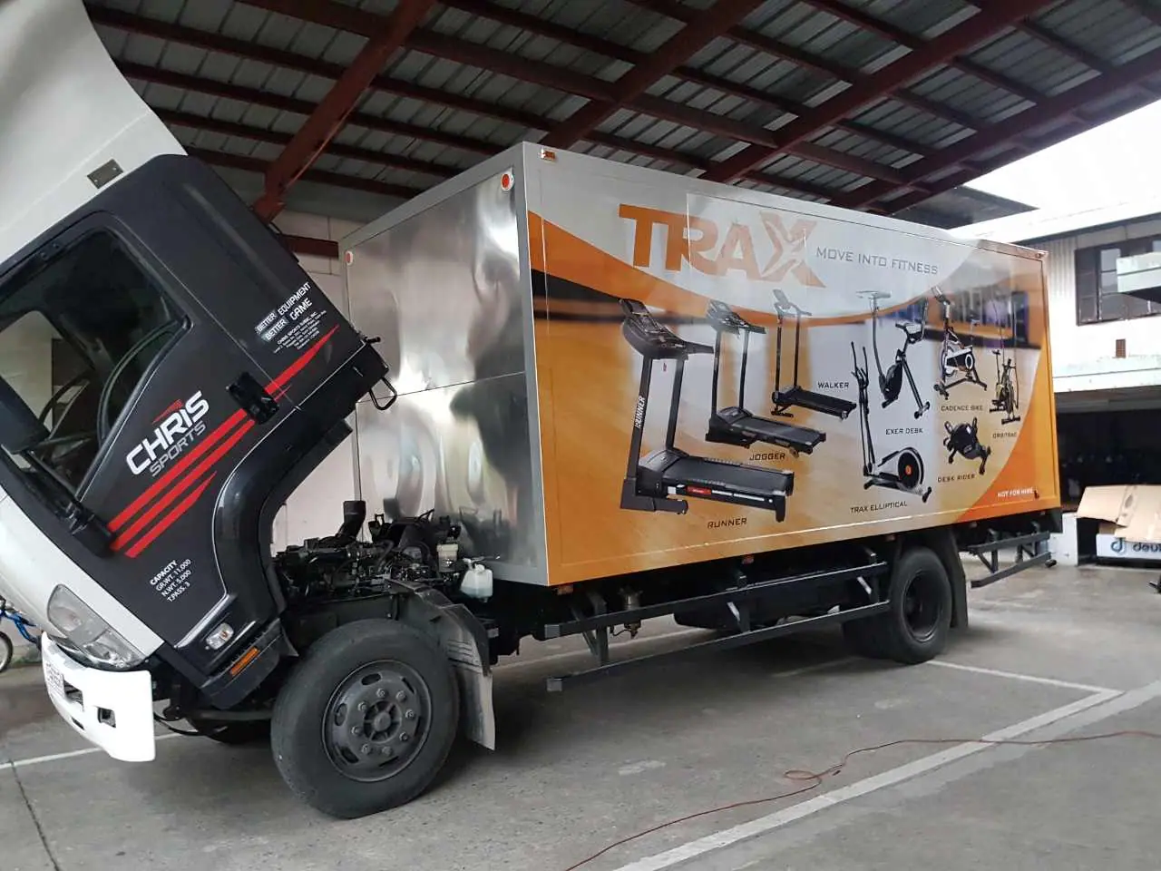Orange fitness equipment graphics on a truck