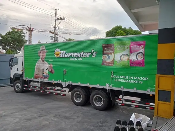 Green full-wrap graphics on a cargo truck