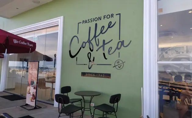 Hand-lettered coffee and tea wall accent in a café