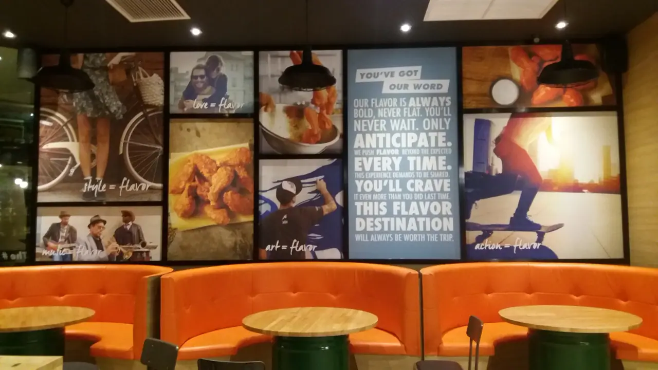 Photo and typography wall mural above restaurant booth seating