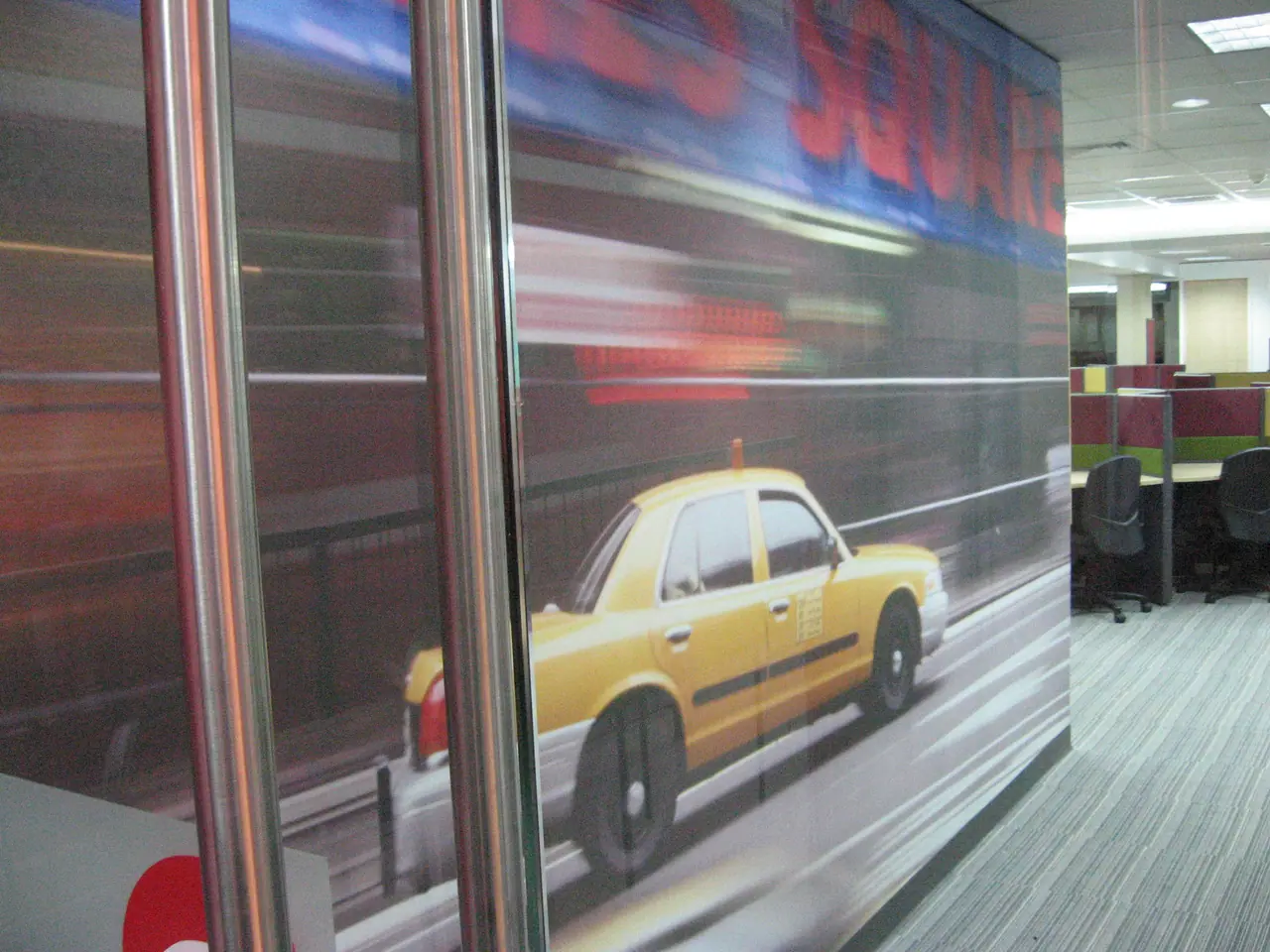 Motion graphic of a taxi printed on an office wall