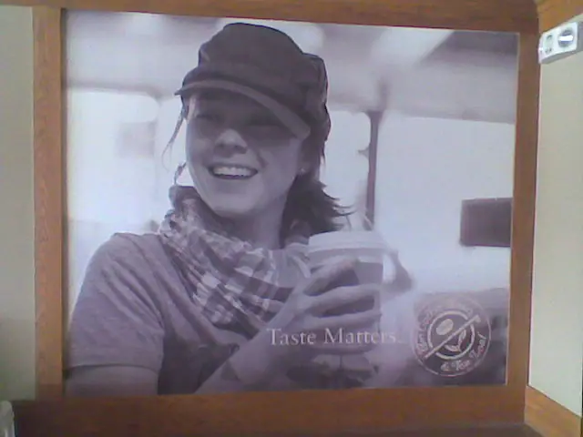 Black-and-white lifestyle photo wall panel in a café